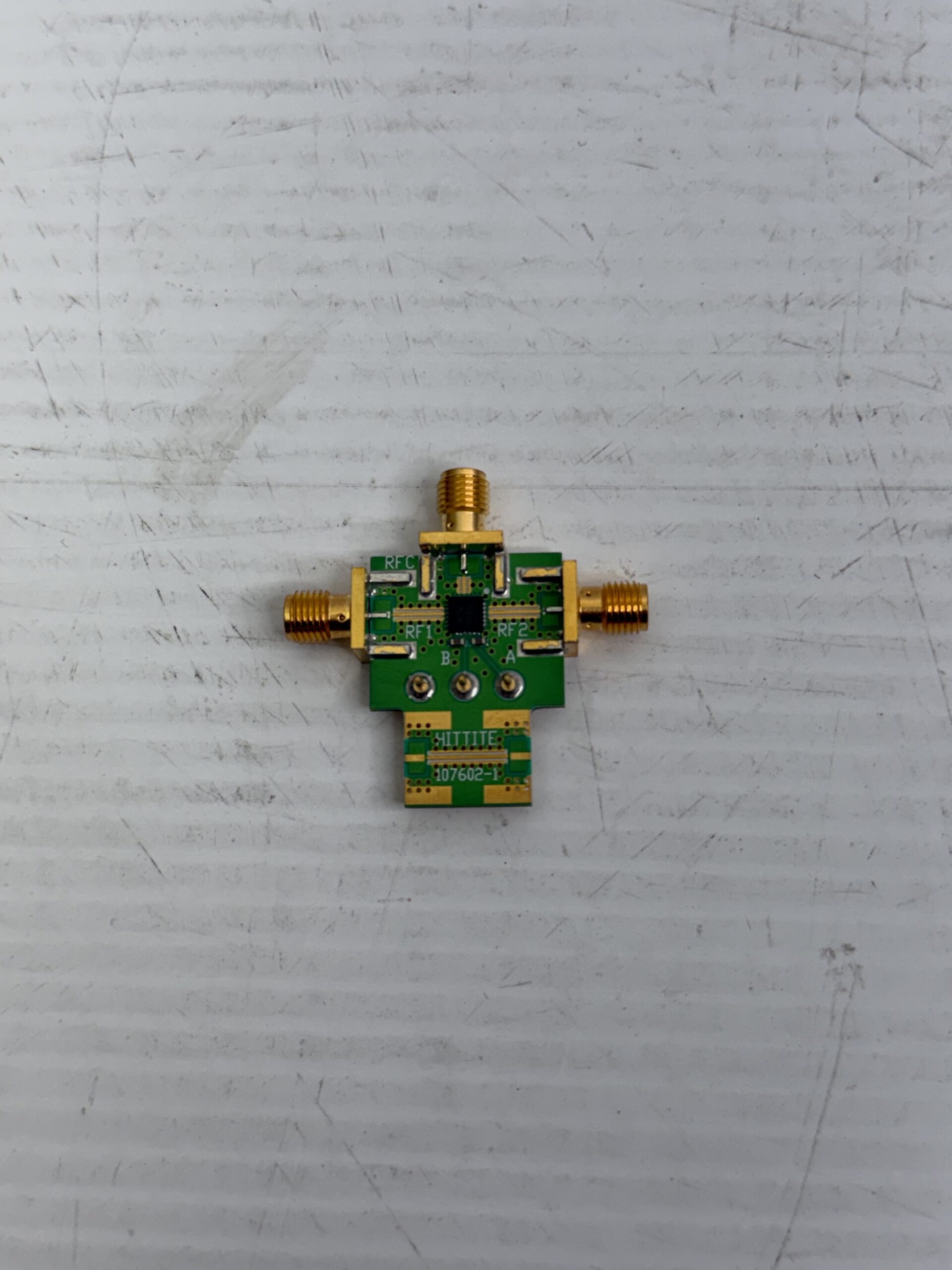 Analog Devices 107723-HMC232LP4 evaluation board featuring the HMC232LP4 SPDT non-reflective RF switch for broadband microwave and RF signal switching from DC to 12 GHz